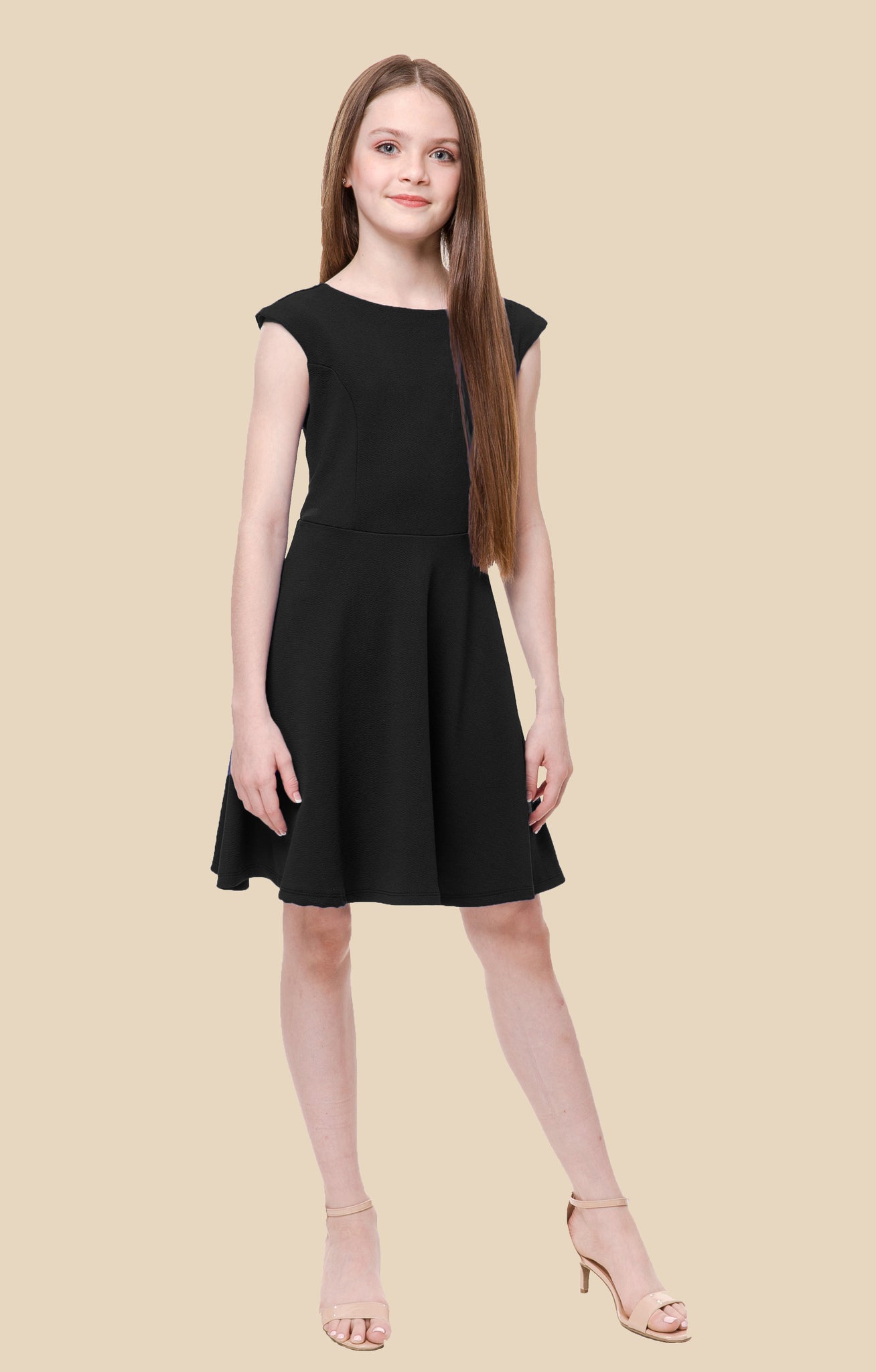 The cap sleeve textured fit and flare dress is shown in black with high neck line, shoulder coverage and lower v-back detailing for a chic and sophisticated look. This dress can be worn to a more coservative special occasion event like cotillion, graduation, or religious service like a bat mitzvah service or church ceremony.