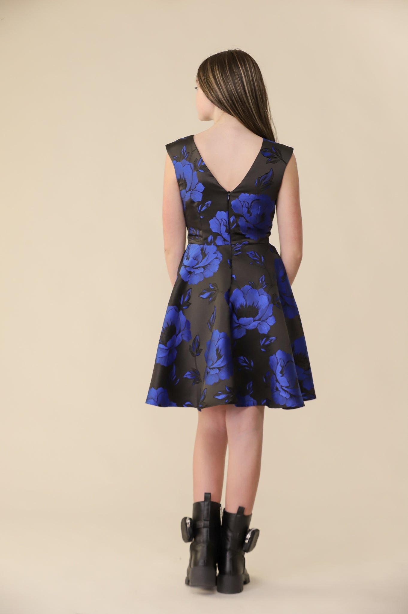 This is an all over satin, cap sleeve dress in a black and cobalt floral print pink with non-stretch material, zipper back, and longer length detailing. This dress is perfect for any religious event like bat mitzvah, cotillion or church service. 