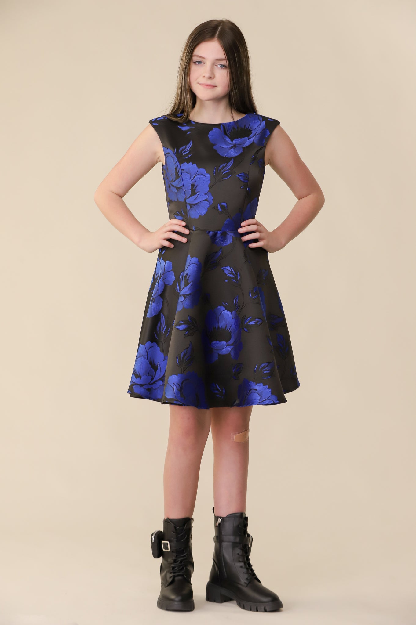 This is an all over satin, cap sleeve dress in a black and cobalt floral print pink with non-stretch material, zipper back, and longer length detailing. This dress is perfect for any religious event like bat mitzvah, cotillion or church service. 