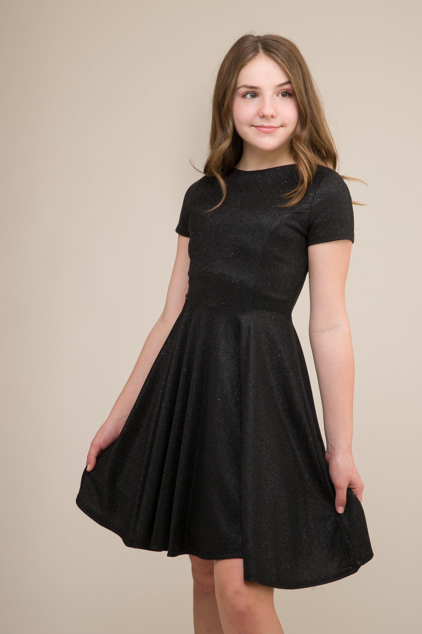 This is an all over black stretch glitter dress made with soft lining. It's non-scratch fabric is a perfect dress that hits right above the knee and has a lower v-back detailing.