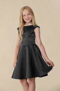 A non-stretch, cap sleeve style, satin dress in black. The slight cap sleeve coverage just covers the tops of the shoulders and v-back detailing in back.