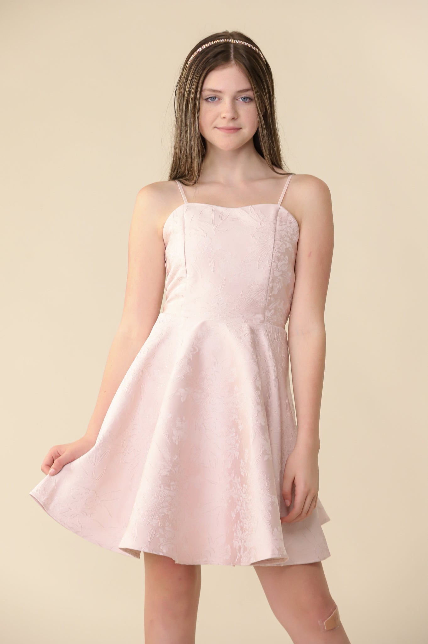 This is an all over, non-stretch floral fabric dress in blush pink. Hits right above the knee for a chic and sophisticated look. It features adjustable straps and full circle skirt.