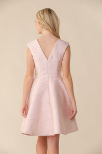 This is an all over jacquard, cap sleeve dress in blush pink with non-stretch material, zipper back, and longer length detailing. This dress is perfect for any religious event like bat mitzvah, cotillion or church service.