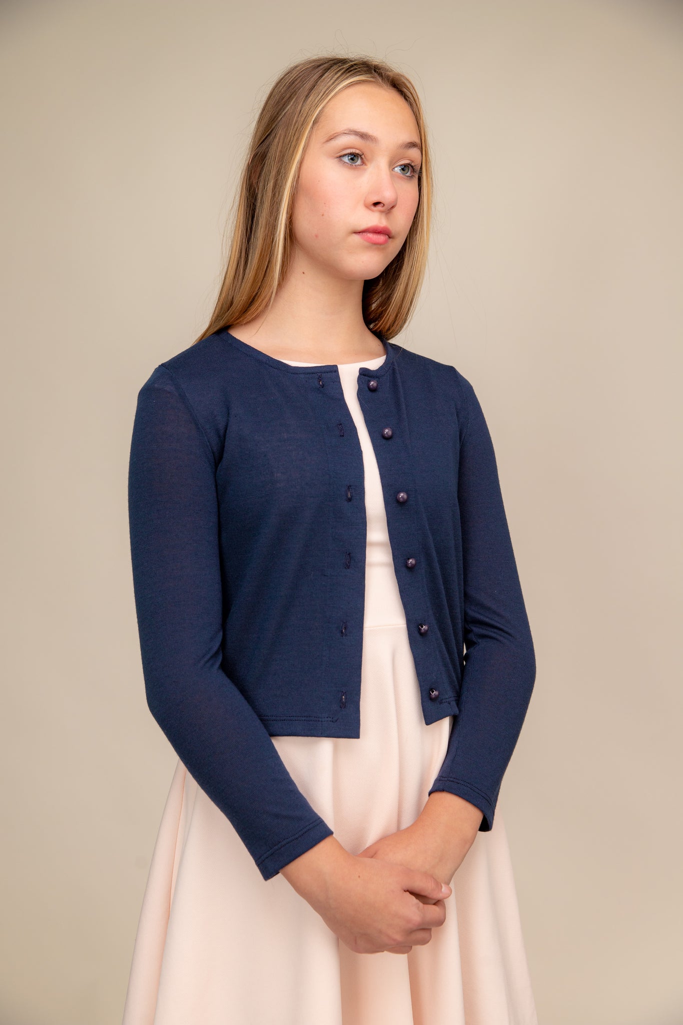 This is a button up cardigan with plastic buttons, scoop neck detailing, three quarter inch sleeve length and all over stretch fabric in navy.