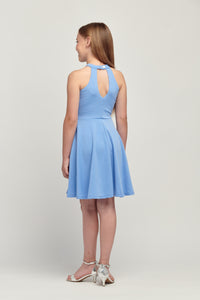 Halter dress in denim features a full circle twirl skirt, open hole detailing in back and high waist line for a chic silhouette.