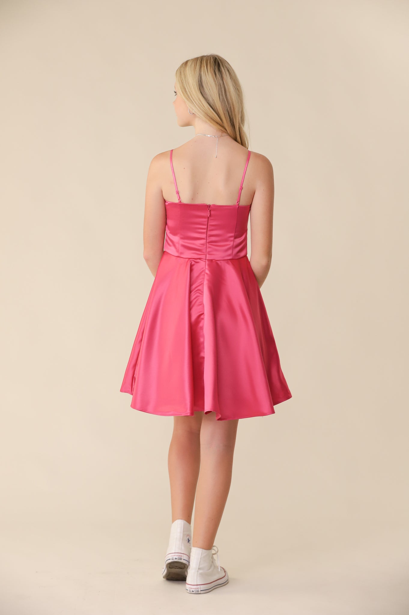 This is an all over, non-stretch satin fabric dress in fuchsia pink. Hits right above the knee for a chic and sophisticated look. It features adjustable straps and full circle skirt.