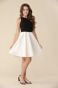 Brown haired girl in a glitter bodice dress with black circle skirt with black kitten heel.