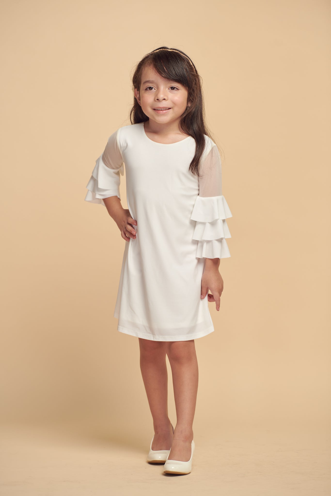 This is an all over stretch, ivory tiered sleeve dress with mesh detailing on the sleeve. Hits above the knee for a beautiful and chic silhouette.