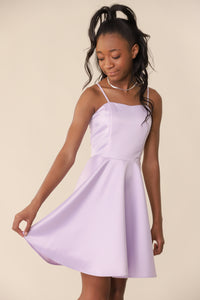 This is an all over non-stretch satin dress with adjustable straps, full circle skirt and features a high waist line. The dress hits above the knee and has a zipper back.