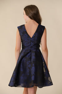 This is an all over jacquard, cap sleeve dress in navy with non-stretch material, zipper back, and longer length detailing. This dress is perfect for any religious event like bat mitzvah, cotillion or church service.