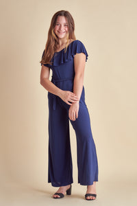 This is the all over stretch jumpsuit in navy with flutter off the shoulder sleeve and knotted belt. Features two real pockets and wide leg detailing.