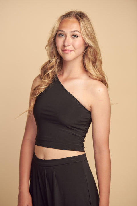 Blonde girl in a black one shoulder crop top.