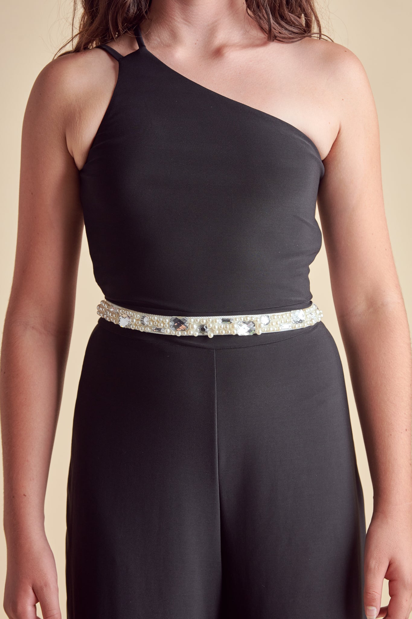 Girl in an ivory elasticated belt with pearl and gems.