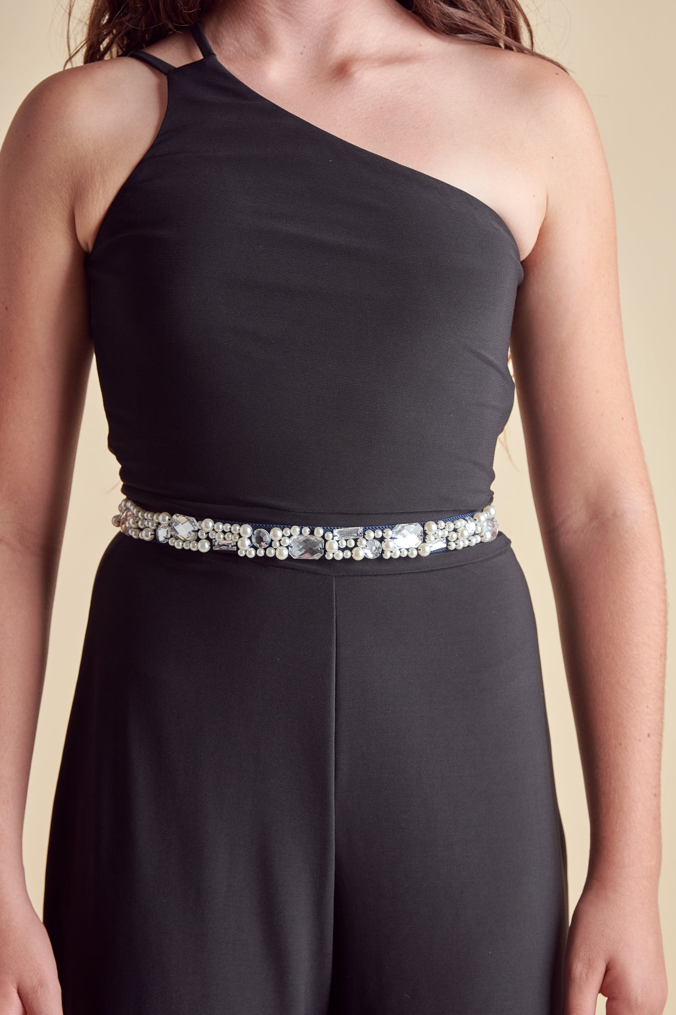 Girl in a navy elasticated belt with pearl and gems.