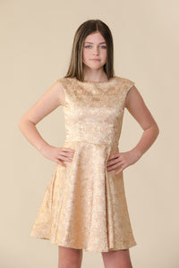 This is an all over jacquard, cap sleeve dress in rose gold with non-stretch material, zipper back, and longer length detailing. This dress is perfect for any religious event like bat mitzvah, cotillion or church service.