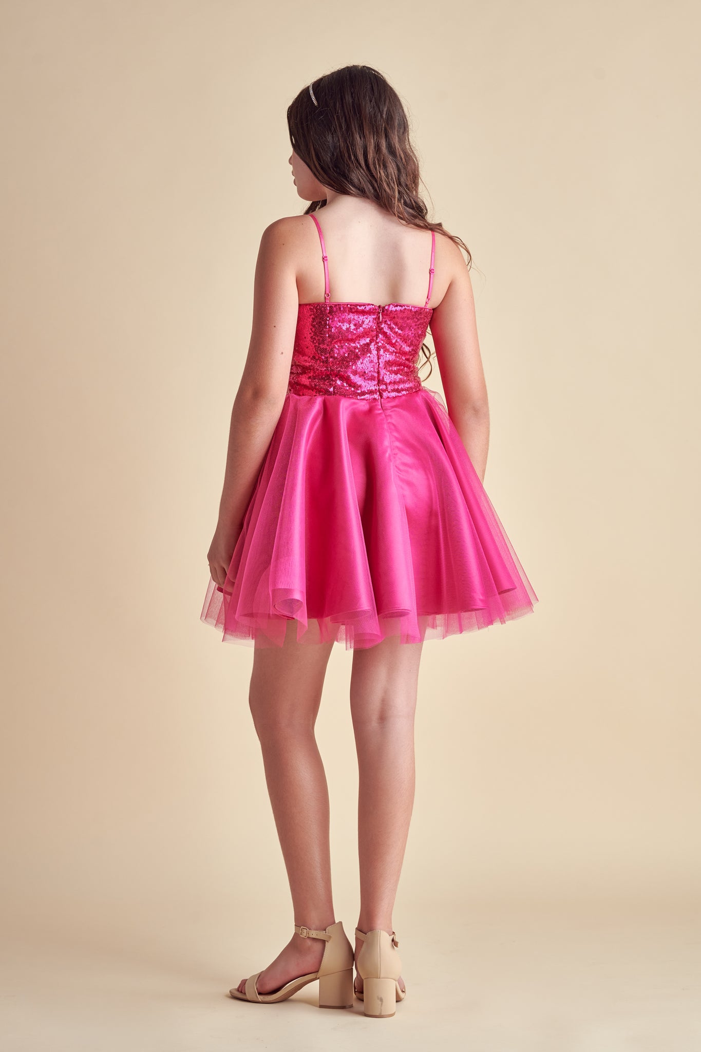 This is sequin bodice dress in fuchsia pink with full tulle skirt with adjustable straps. Hits above the knee with zipper back detailing. This perfect bat mitzvah dress or party outfit for any girl.