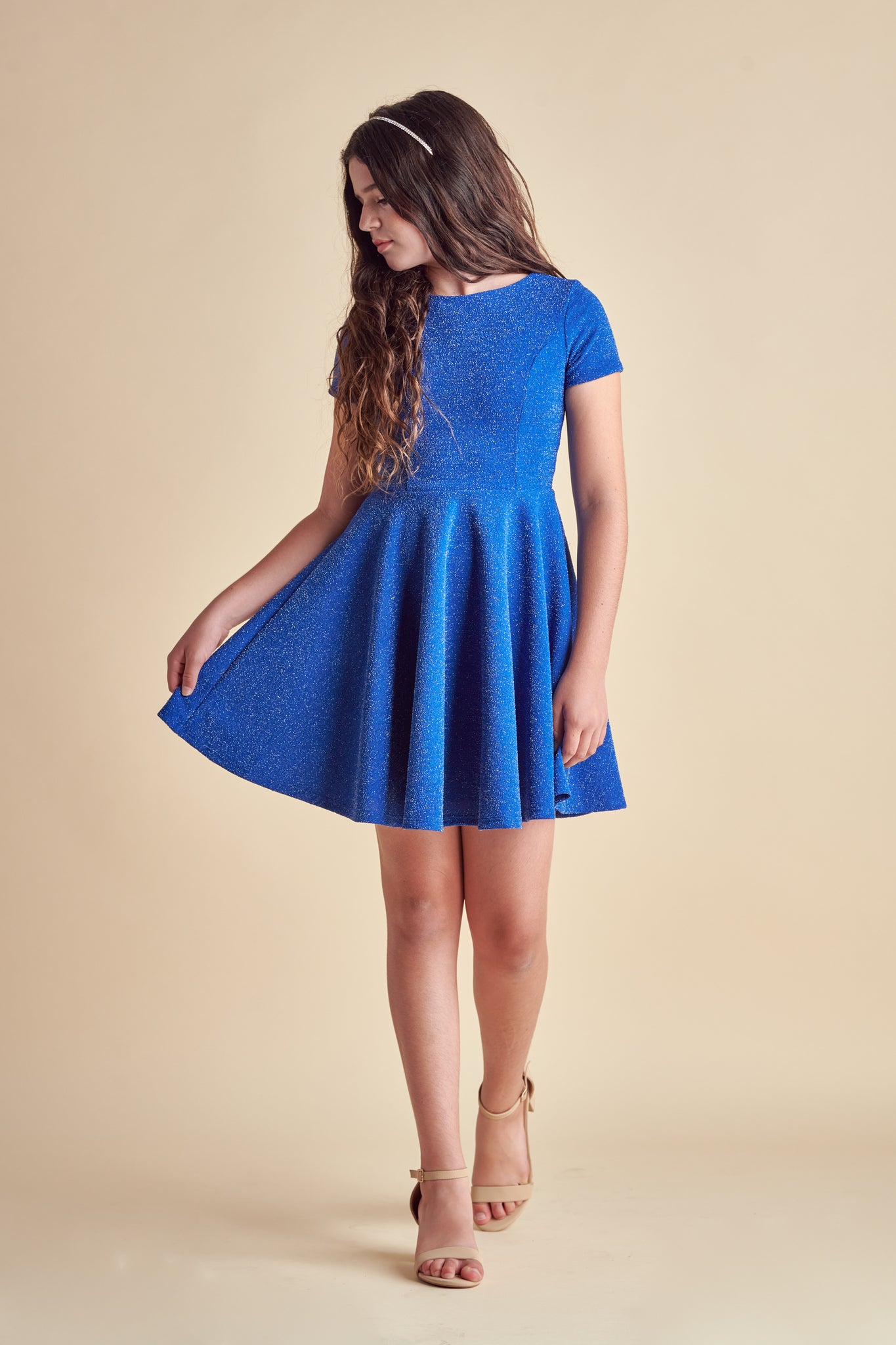 This is an all over cobalt stretch glitter dress made with soft lining. It's non-scratch fabric is a perfect dress that hits right above the knee and has a lower v-back detailing.