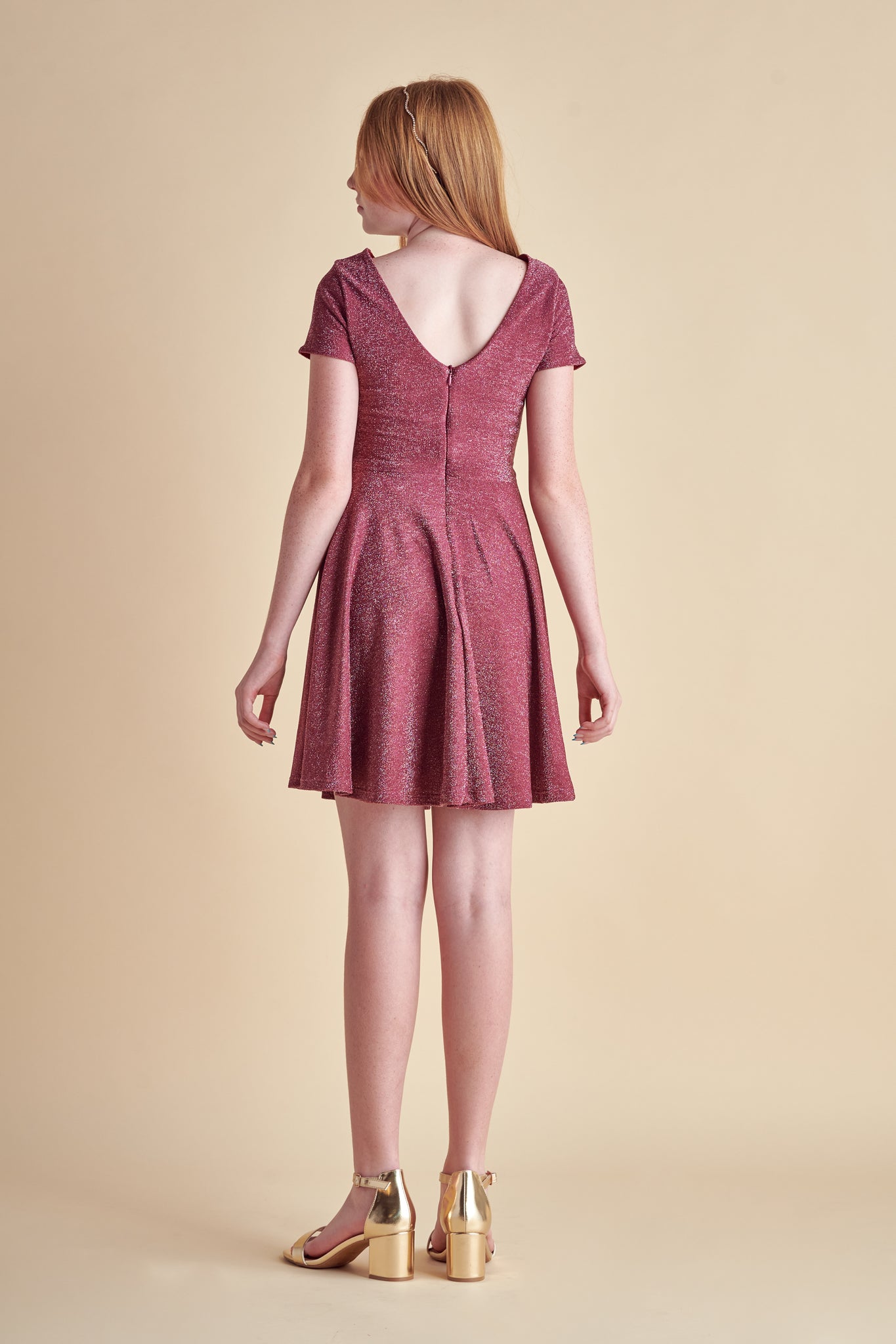 This is an all over wine burgundy stretch glitter dress made with soft lining. It's non-scratch fabric is a perfect dress that hits right above the knee and has a lower v-back detailing.