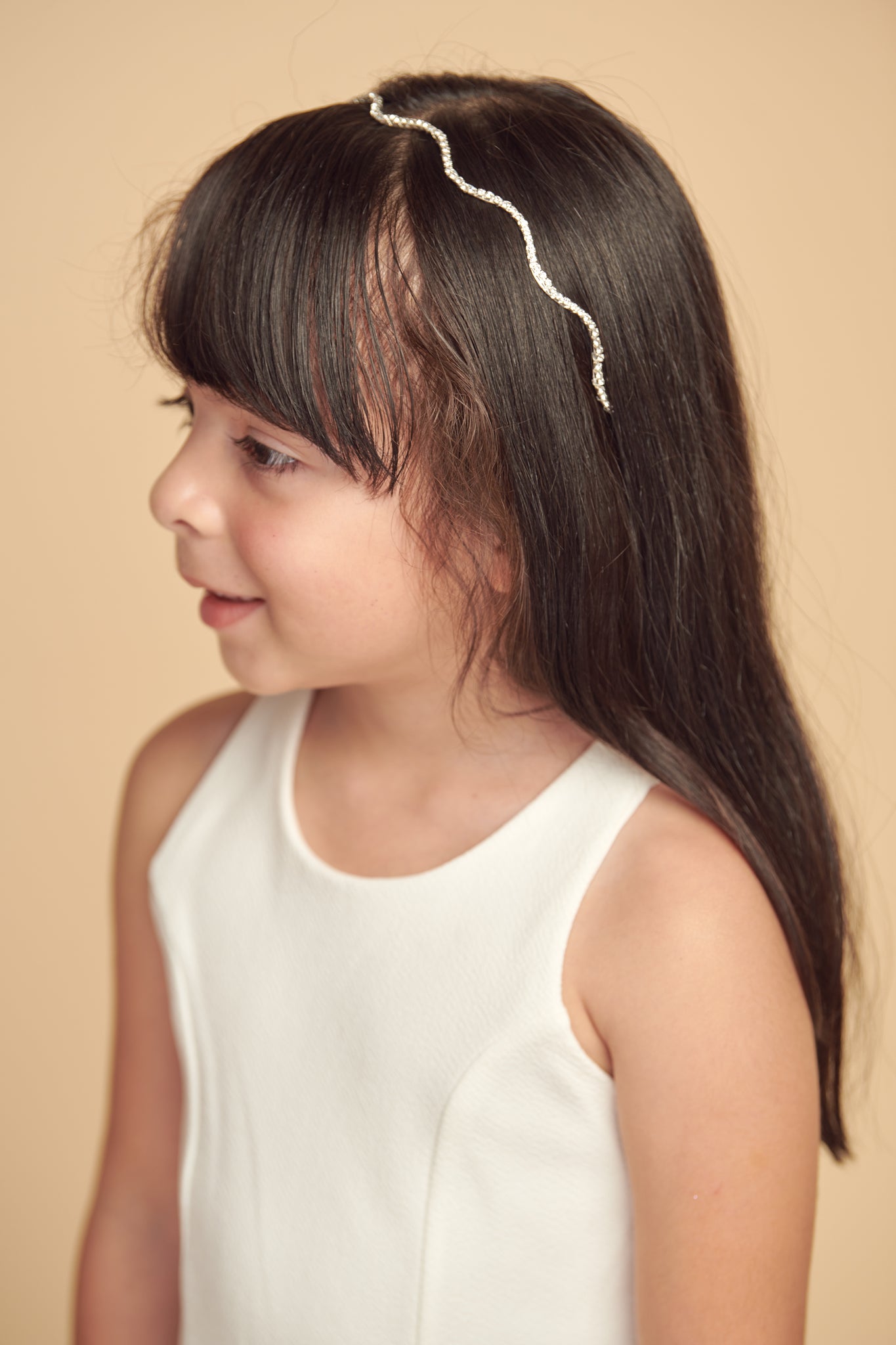 Crystal headband with scalloped rhinsteones. Made for young girls, tweens. teens and women. Has a soft base for comfort.