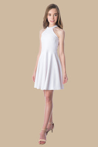 Halter dress in white features a full circle twirl skirt, open hole detailing in back and high waist line for a chic silhouette.